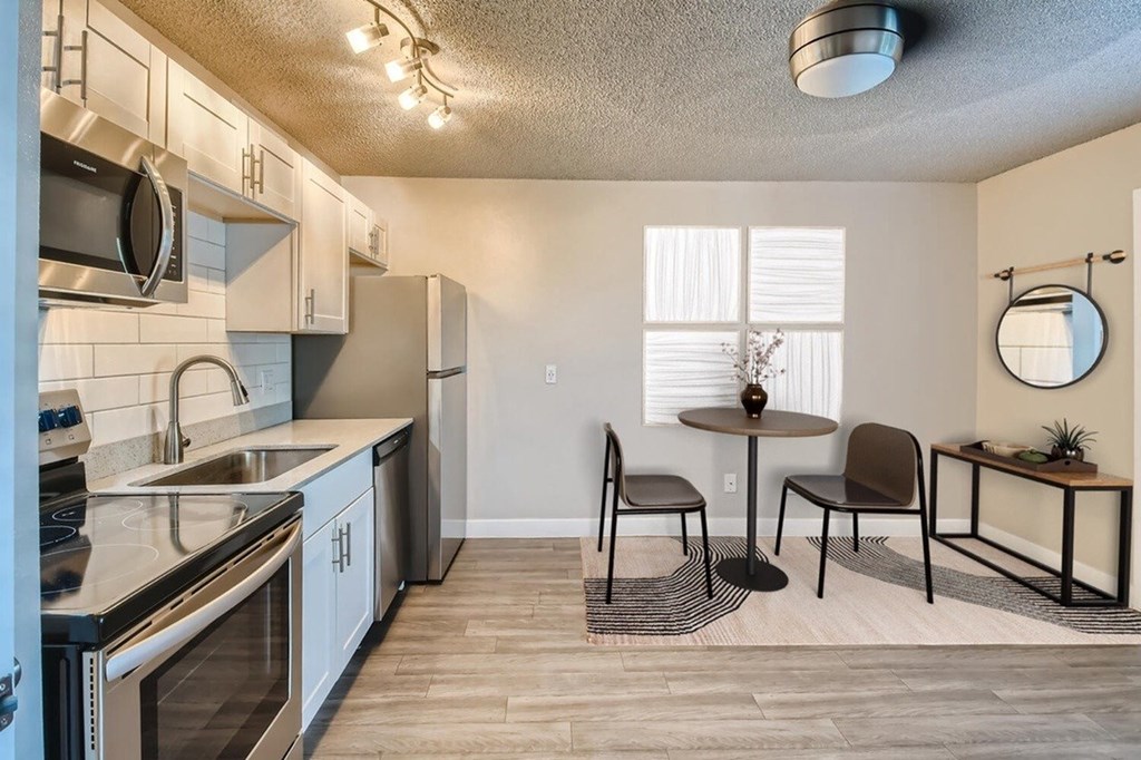 A modern kitchen with a dining table set up.