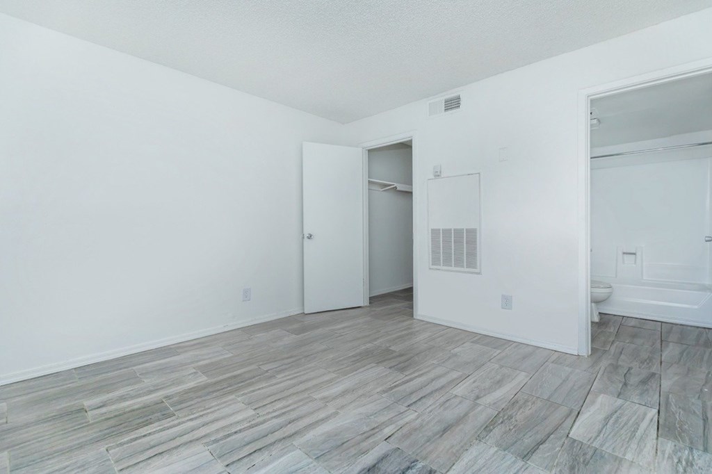 A room with a wooden floor and white walls.