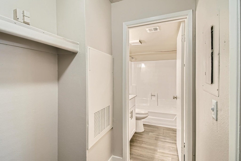 A white bathroom with a toilet, sink, and bathtub.
