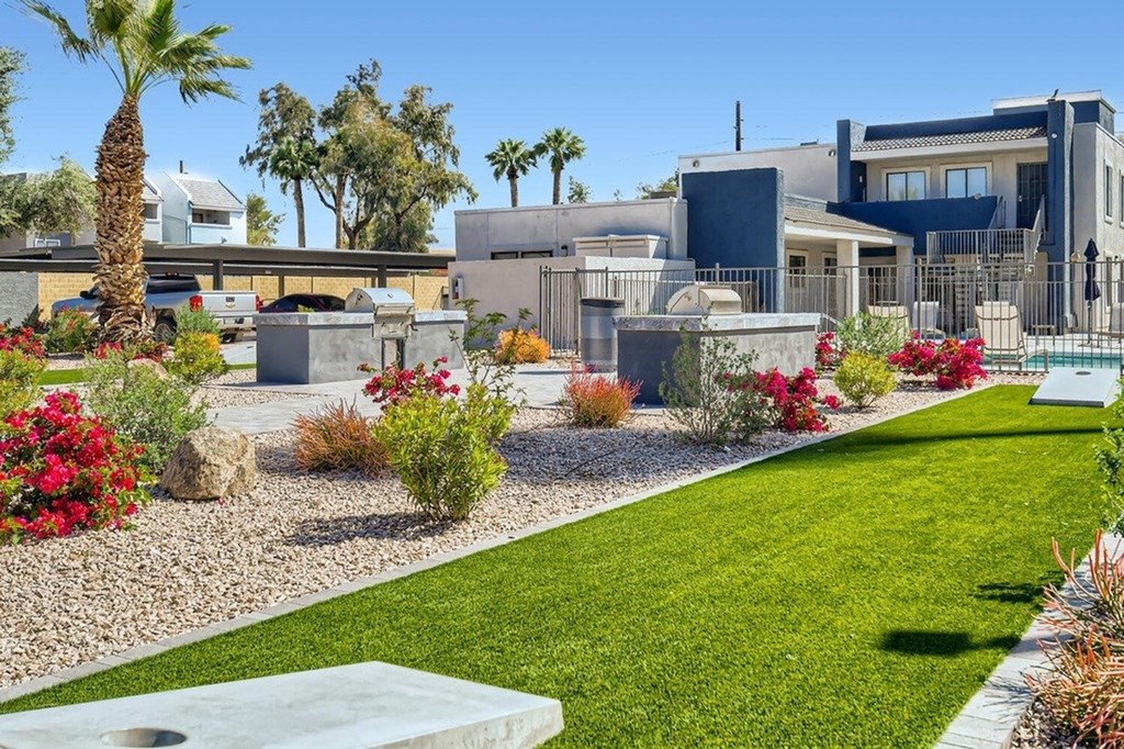 A modern house with a well-maintained garden in front.