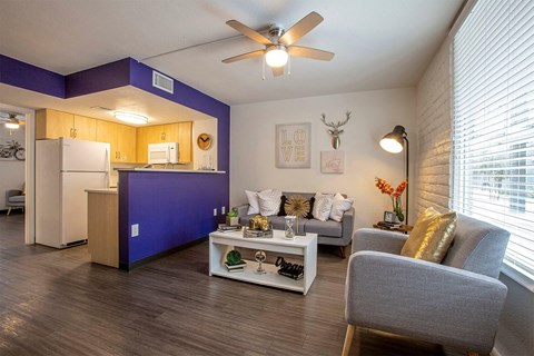 A living room with a grey sofa and a white coffee table.