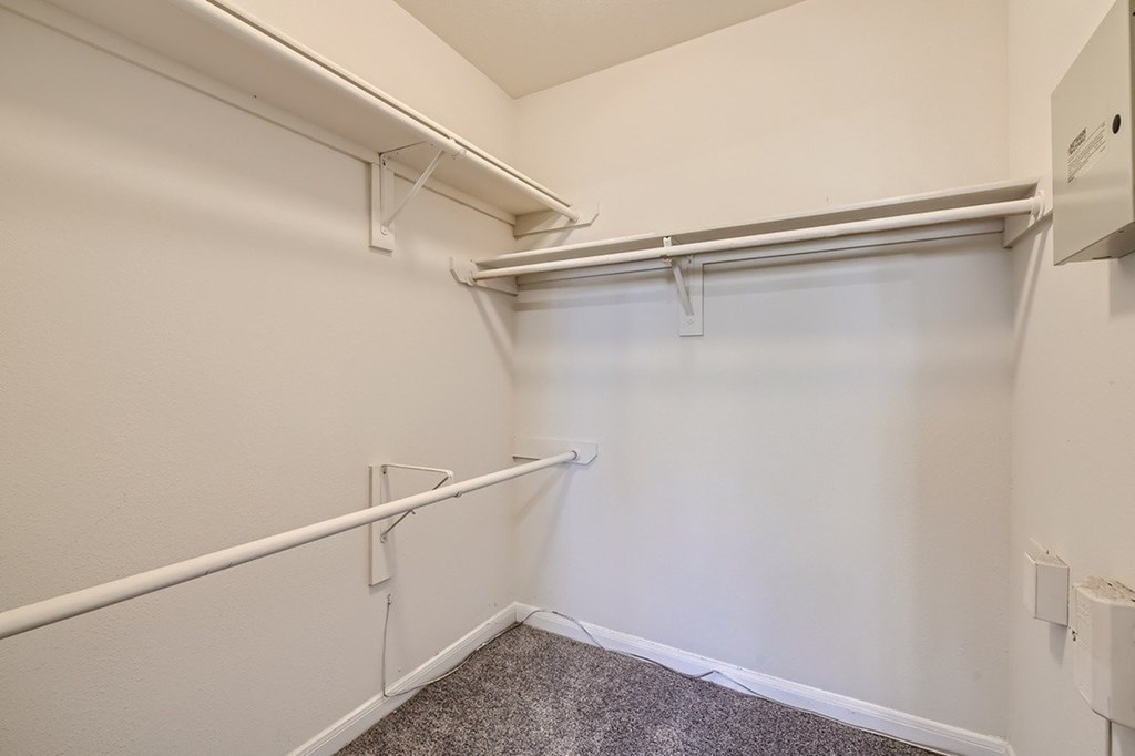 A white wall with a white pipe and a white ceiling.