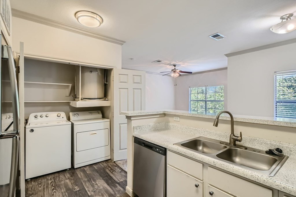 A small kitchen with a washer and dryer.