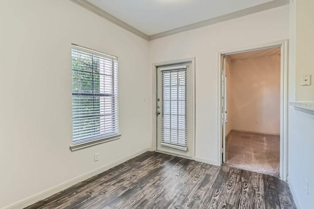 A room with a window and a door.