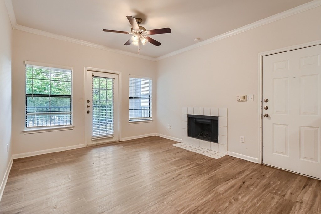 A room with a fireplace and a ceiling fan.
