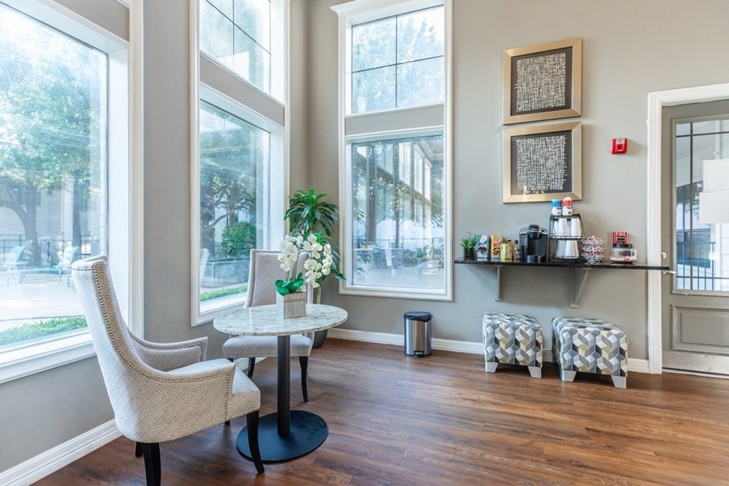 A room with a table, chairs, and a window.
