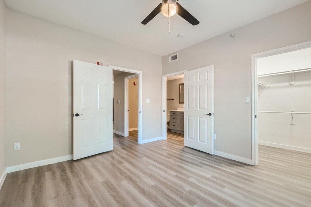 A room with white walls and a ceiling fan.