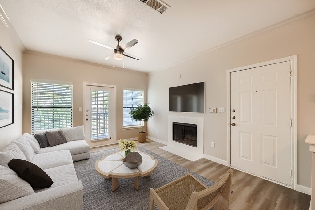A living room with a white couch and a coffee table.