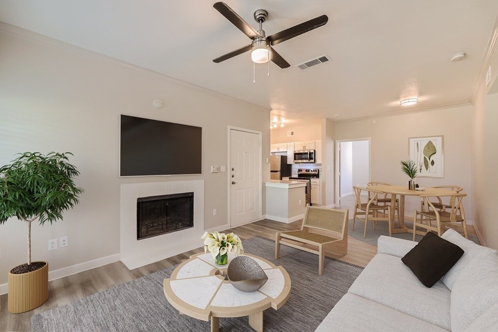 A living room with a fireplace, a television, and a dining table.