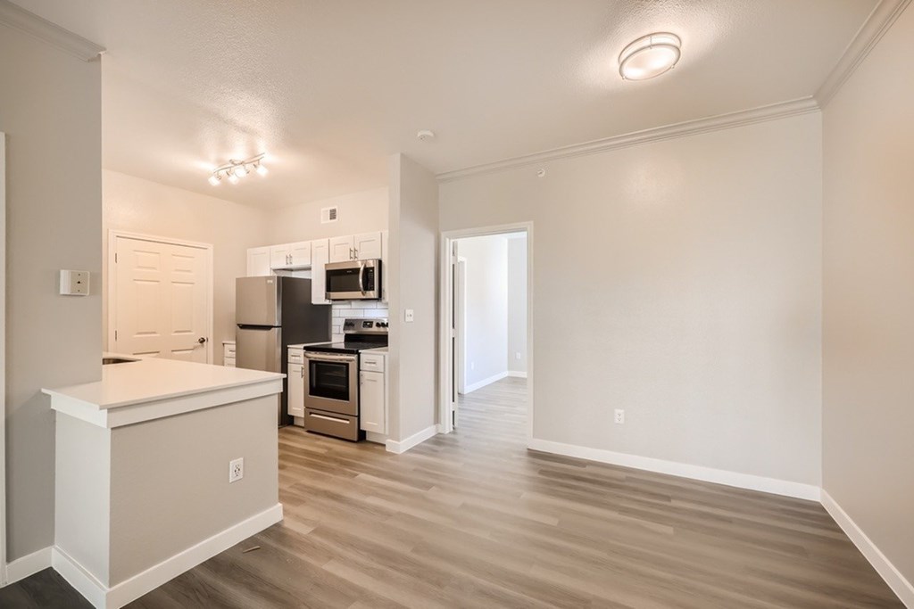 A kitchen with a white countertop and stainless steel appliances.