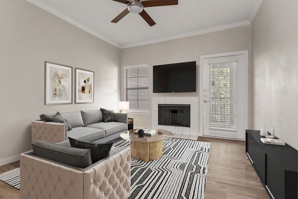 A living room with a grey couch, a coffee table, and a television.