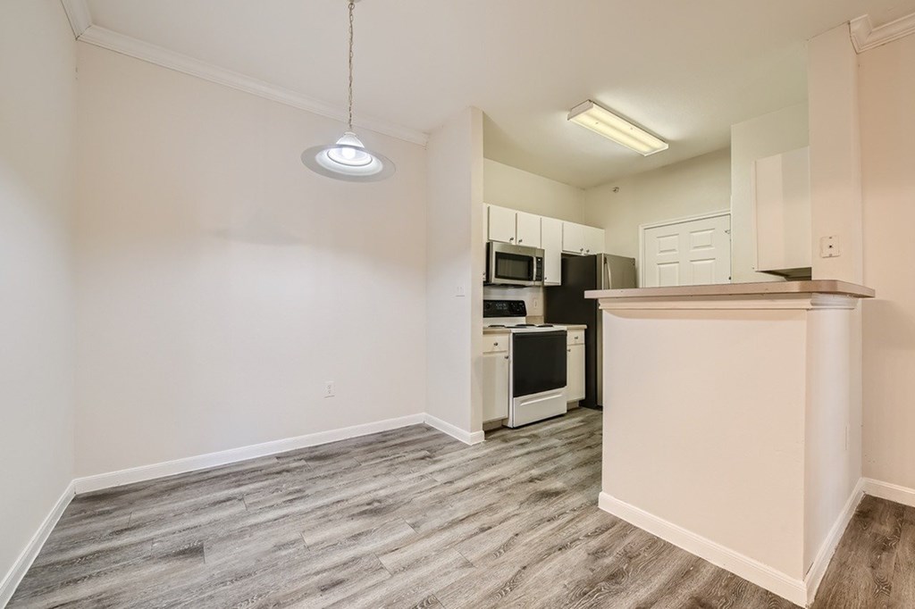 A kitchen area with a microwave, oven, and dishwasher.