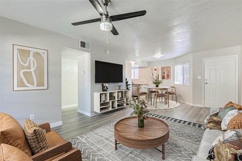 A living room with a brown leather couch and a wooden coffee table.