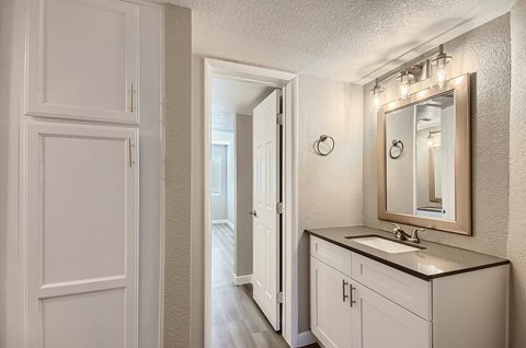 A bathroom with a sink and mirror.
