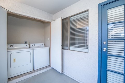 A small bathroom with a washer and dryer.