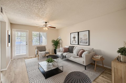A living room with a couch, chair, and coffee table.