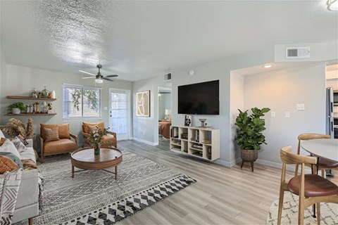 A living room with a couch, chairs, and a coffee table.