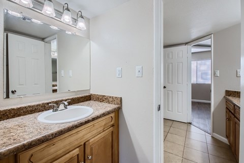A bathroom with a sink and mirror.