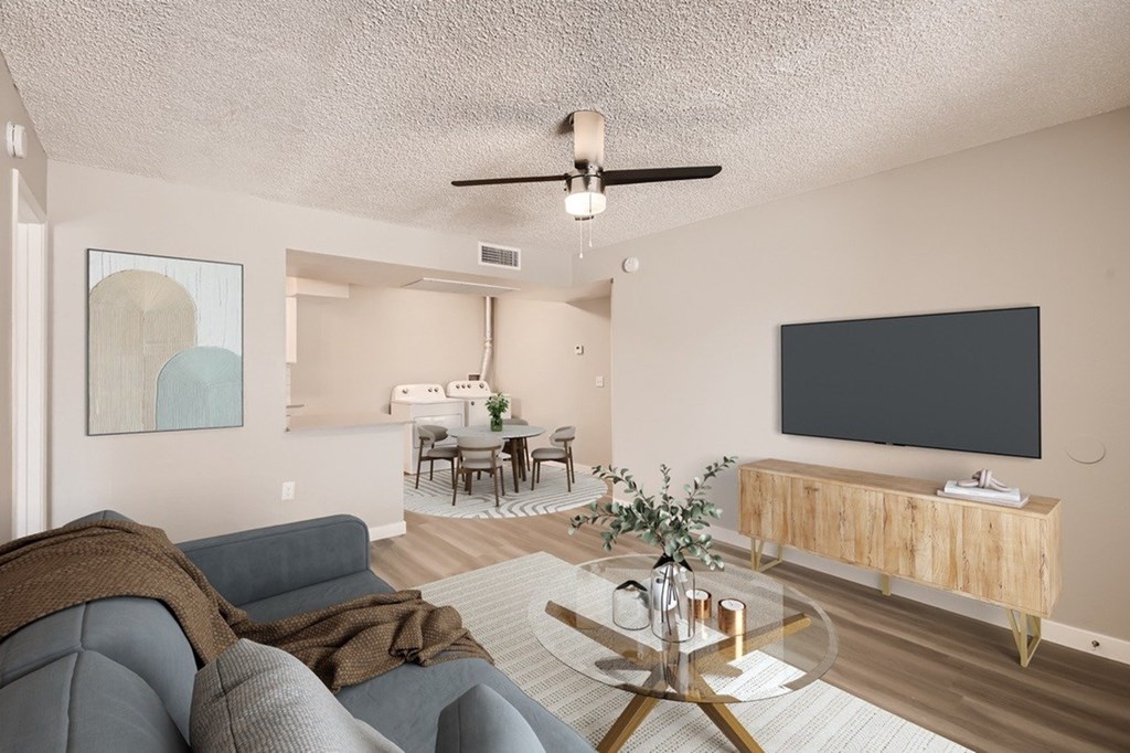 A living room with a grey sofa and a wooden coffee table.