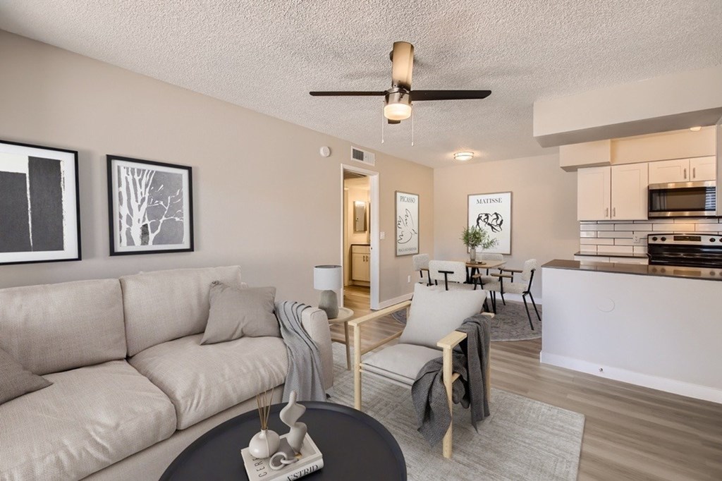 A living room with a grey couch and a black coffee table.