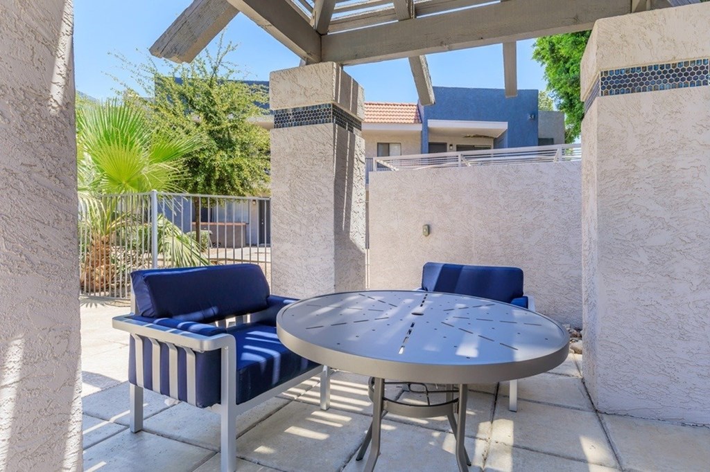 A patio with a table and two chairs.