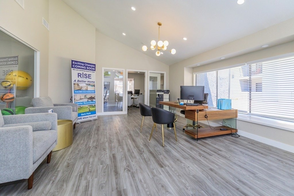A living room with a grey sofa, a wooden coffee table, and a TV.