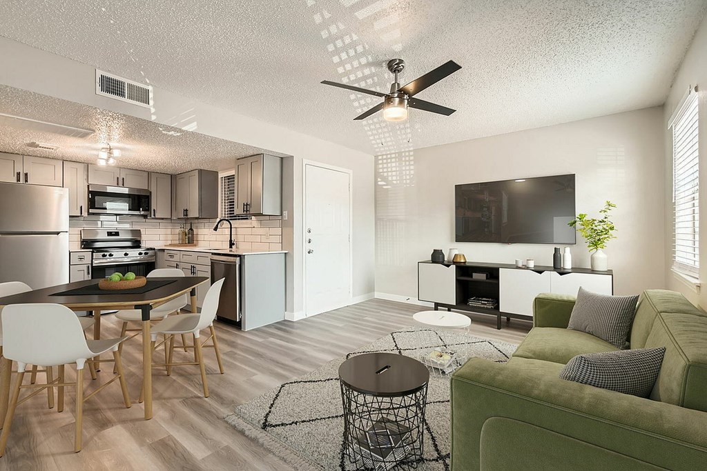 A modern kitchen with a dining table and chairs.