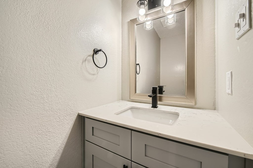 A bathroom sink with a mirror above it.