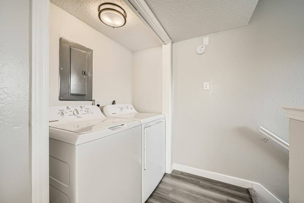 A small bathroom with a washer and dryer.