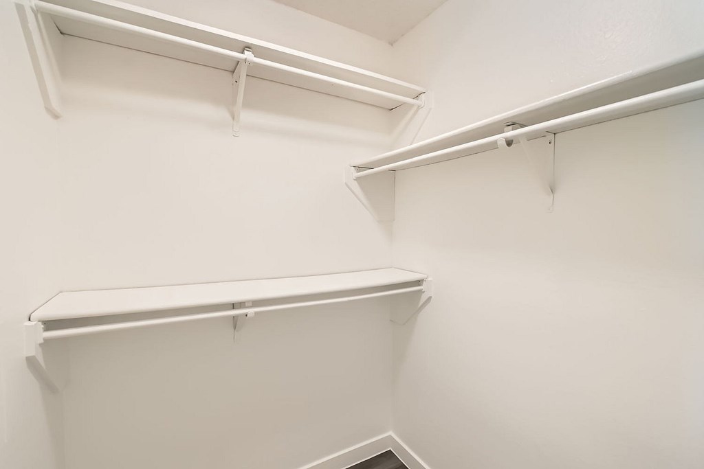 Empty white shelves in a room.