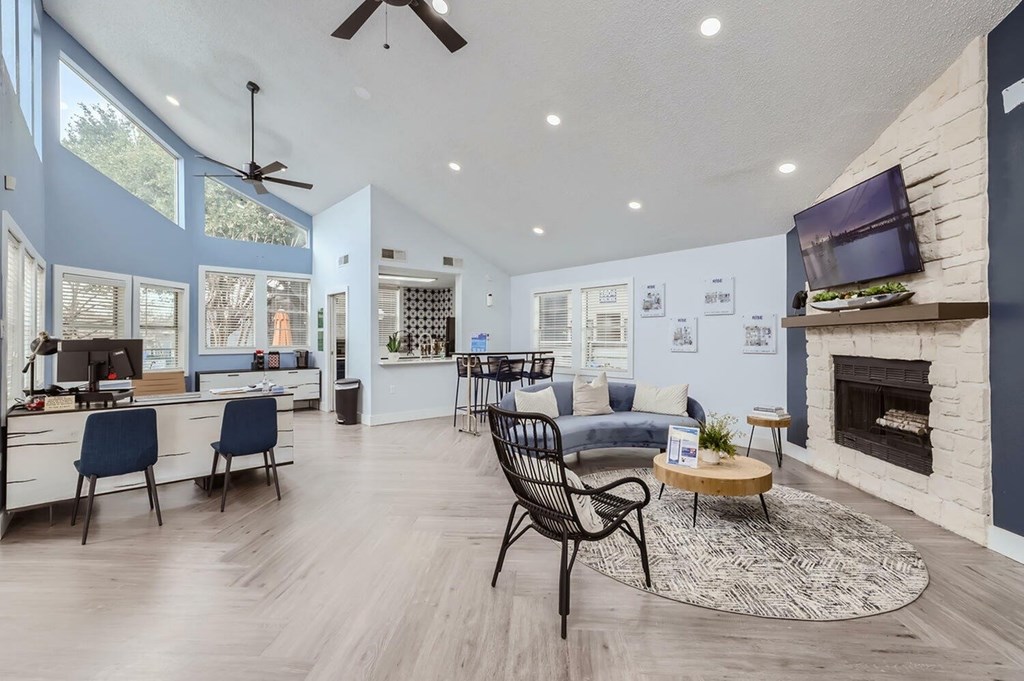A modern living room with a fireplace and a television.