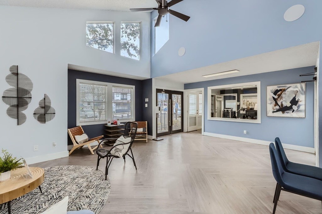 A living room with a ceiling fan and a couch.
