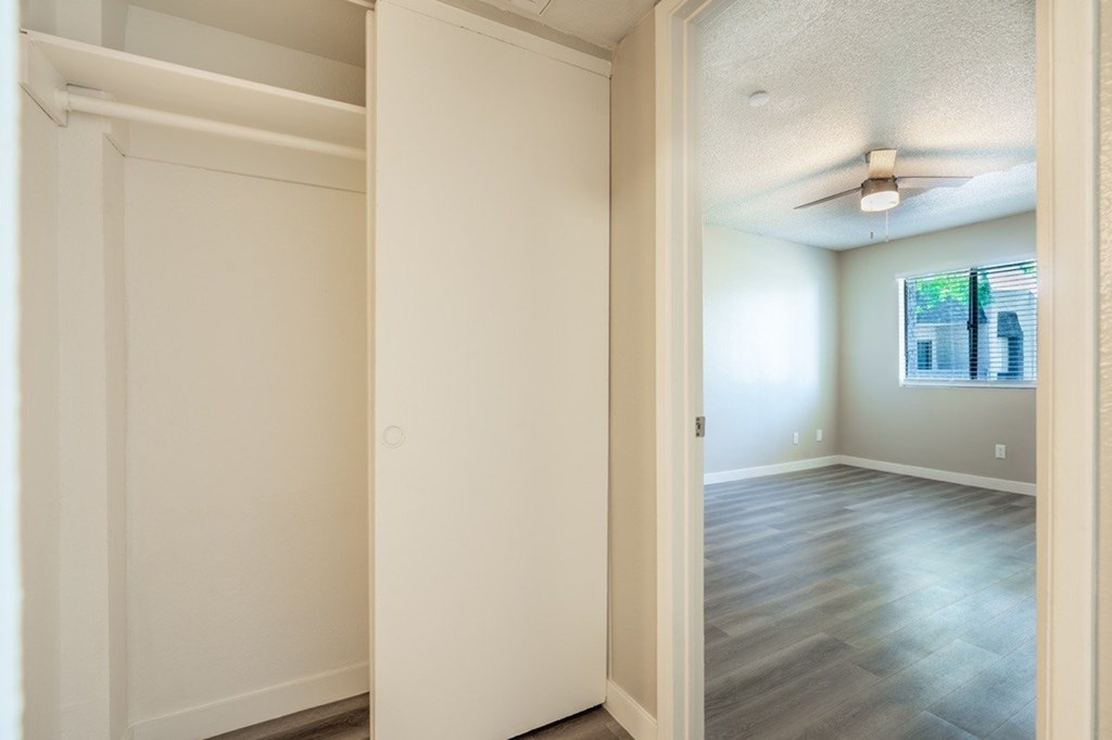 A room with a ceiling fan and a window.