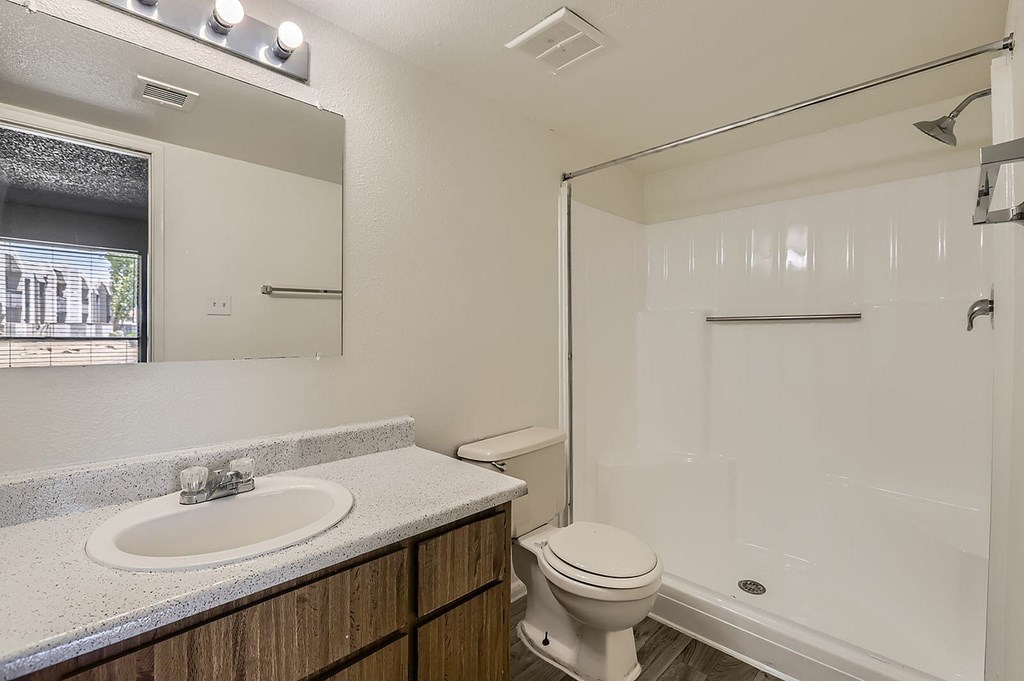 A white toilet sits next to a sink in a bathroom.