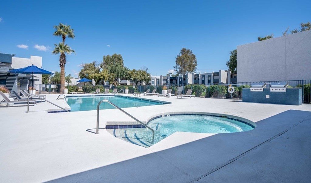 A pool with a slide and a palm tree.