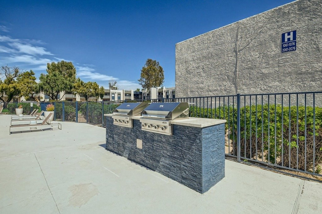 A hospital sign is on a stone wall.