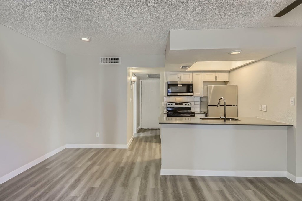 A kitchen area with a microwave, oven, and sink.
