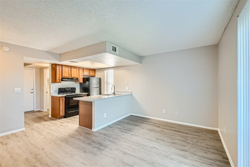 A kitchen with wooden cabinets and a white island.