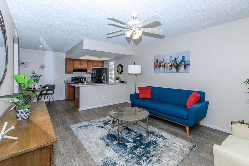 A blue couch sits in a living room with a coffee table in front of it.