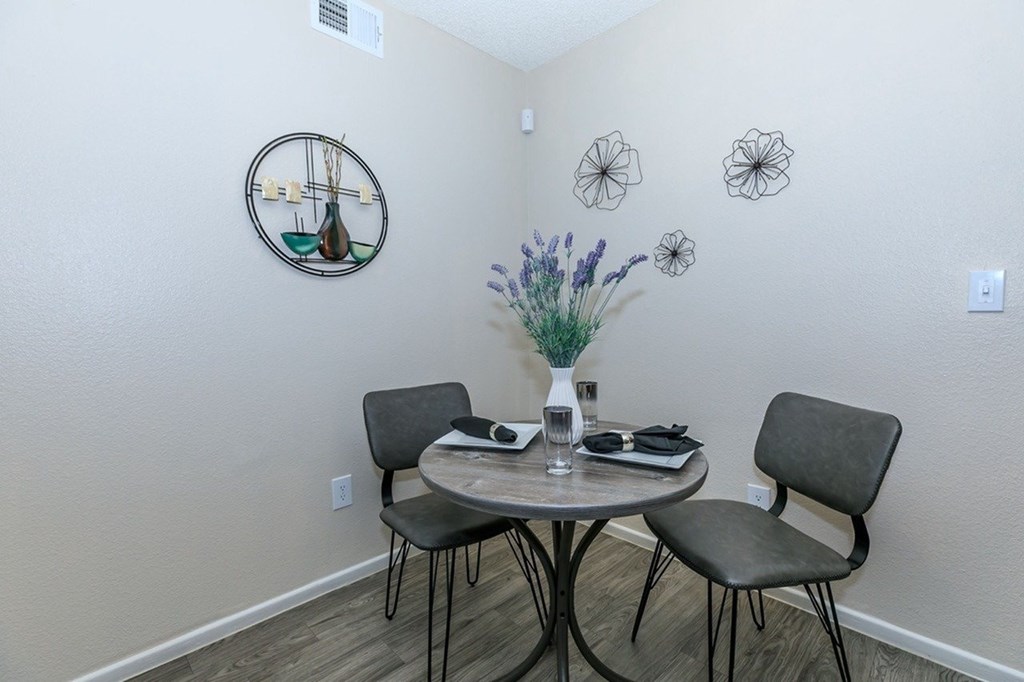 A dining room with a round table and chairs.
