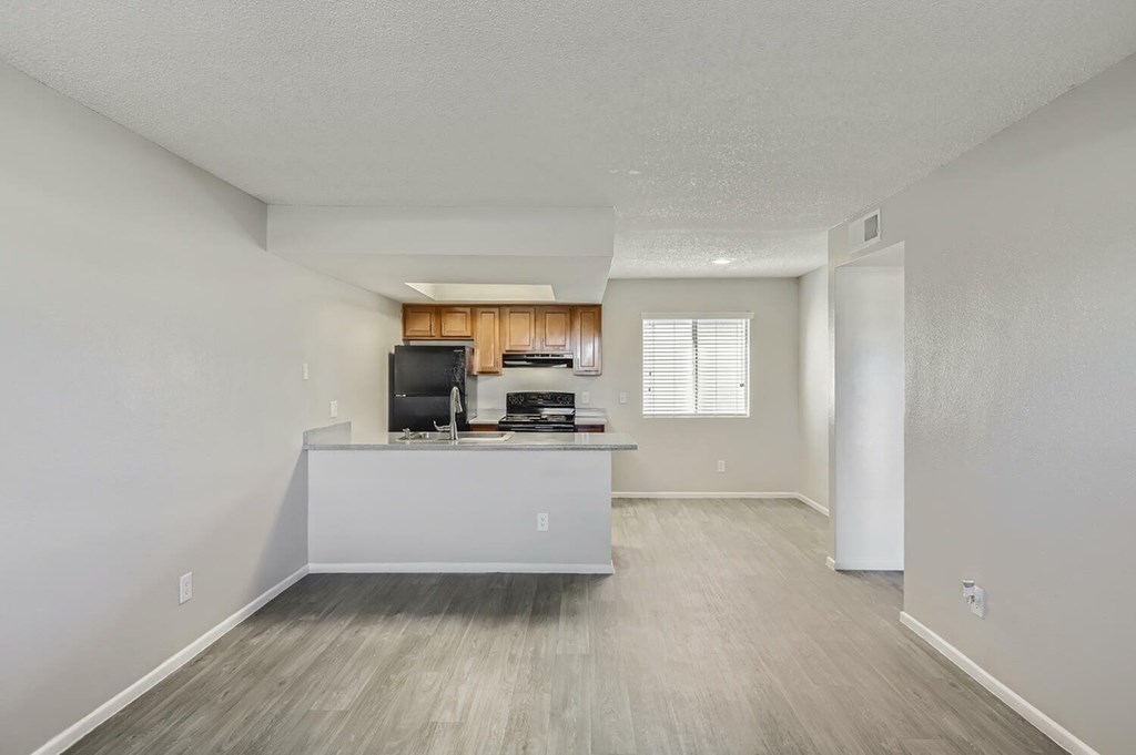 A spacious room with a desk and a television.