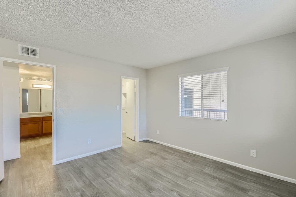 A room with a wooden floor and white walls.