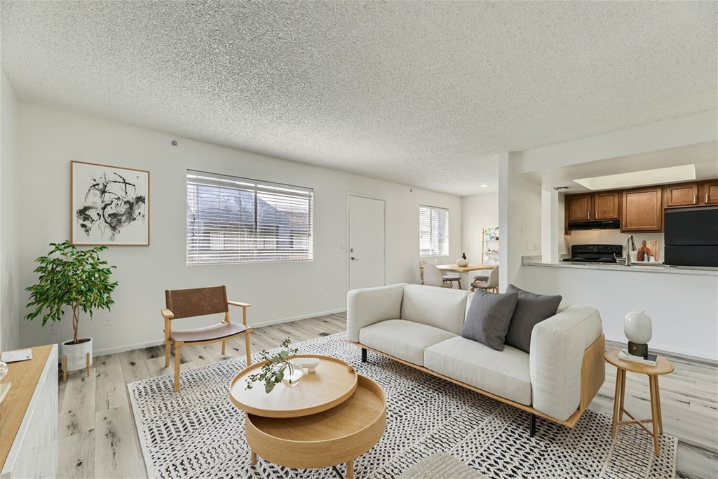 A living room with a couch, chair, and coffee table.