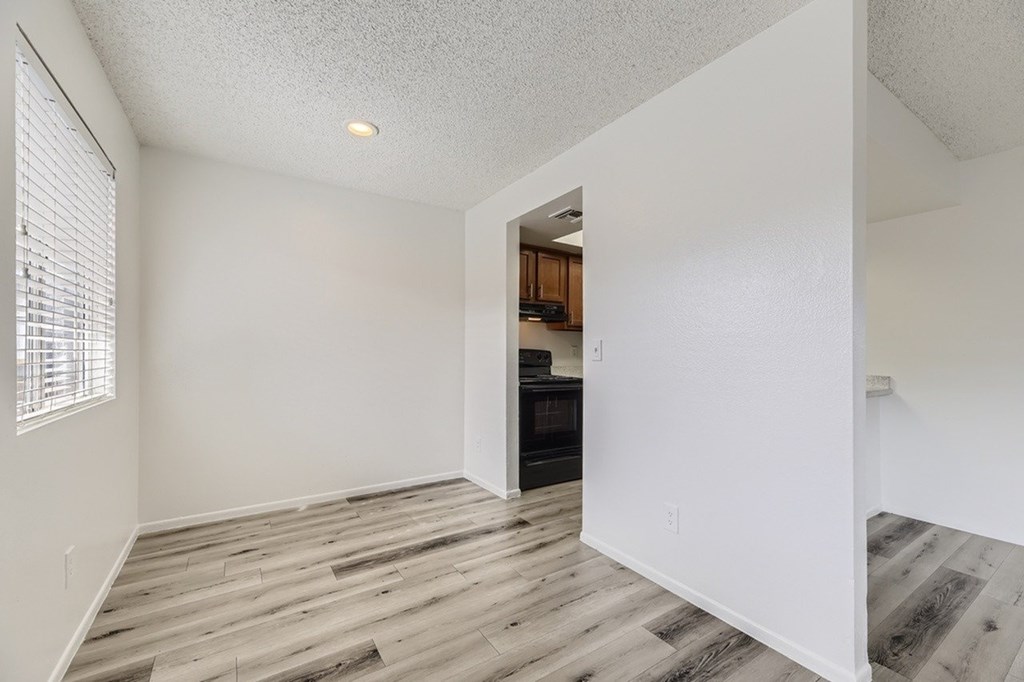 A room with a wooden floor and white walls.