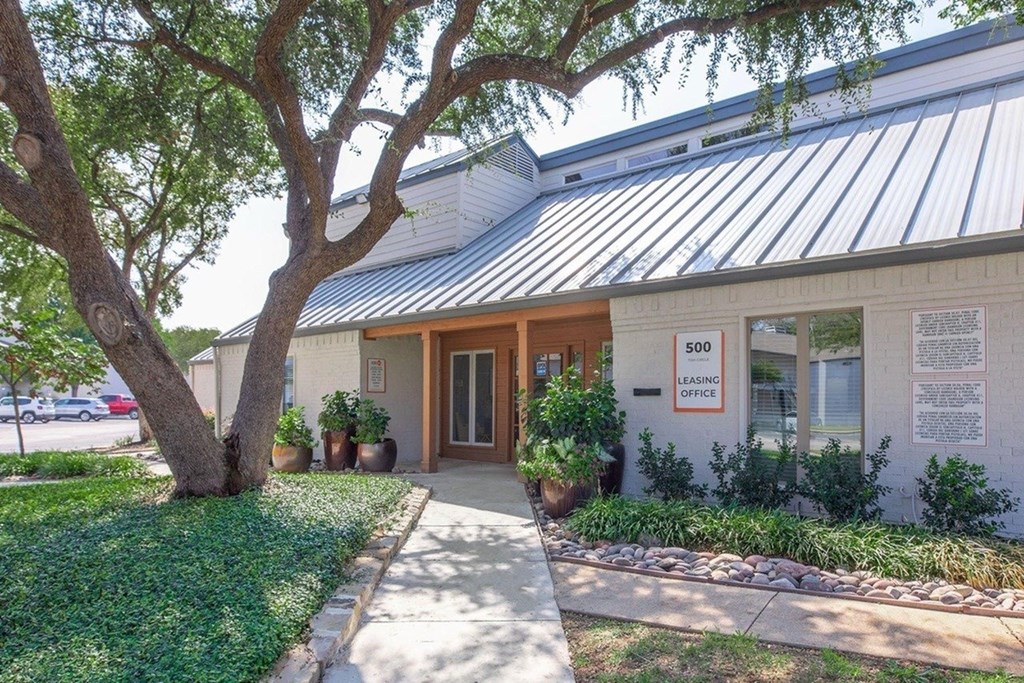 The image shows a building with a sign that reads "500 LEASING OFFICE".