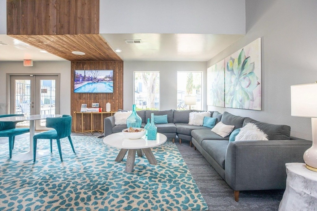 A living room with a grey couch and a blue chair.