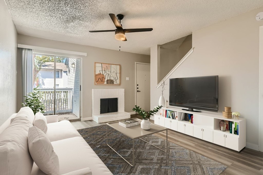A living room with a white couch and a television.