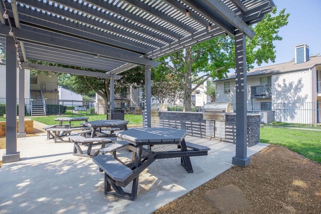 A covered picnic area with tables and benches.