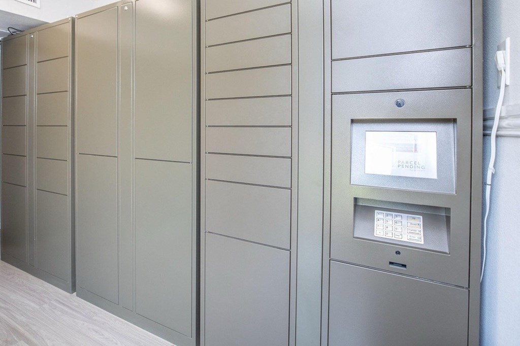 A row of metal lockers with a keypad on the right.
