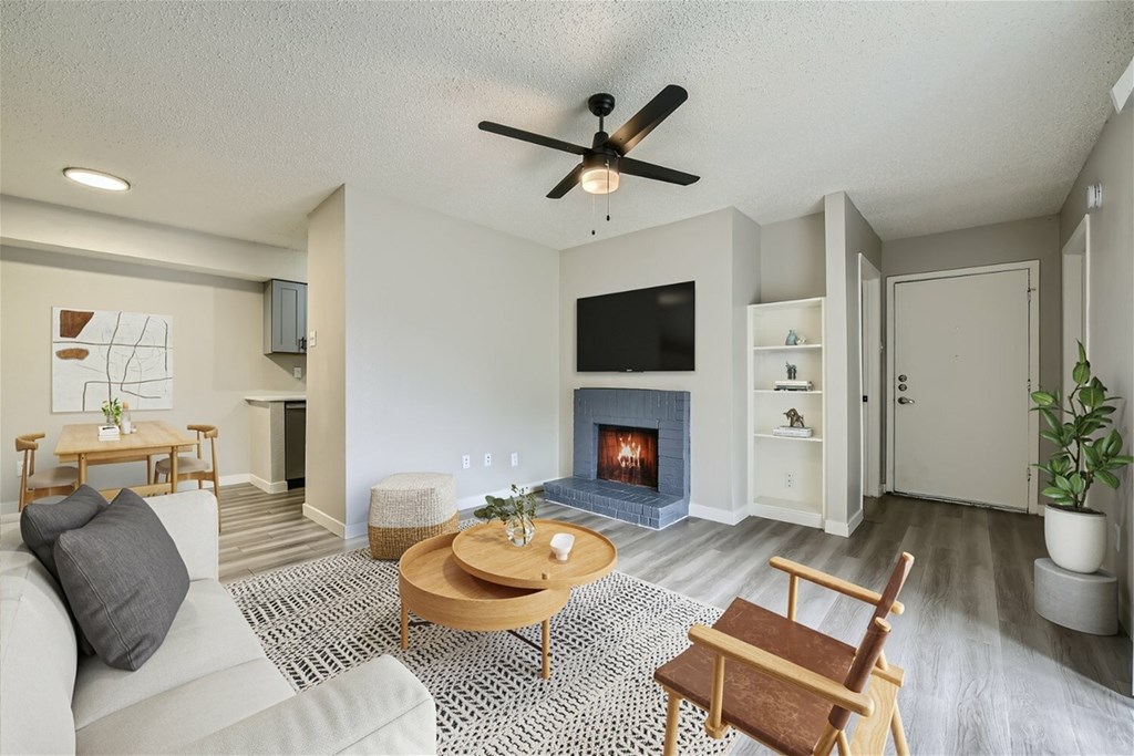 A living room with a fireplace and a television.
